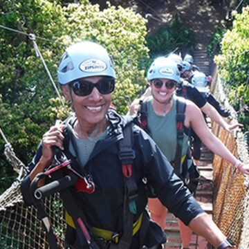 Clolita on rope bride to zip line in Maui, Hawaii.